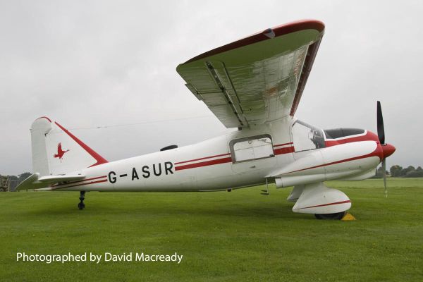 Dornier Do 28 A-1, G-ASUR, red on white, right side, parked on grass