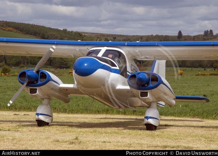 Dornier Do 28 A-1, N123CA, blue on white, on the ground from the front with one propellor turning